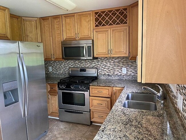 Photo - Spacious 5BR/2BA Single Family | Fresh Paint + New Carpet | New Kitchen Floor | Huge Yard + Deck