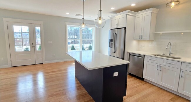 Kitchen with Large Island Workspace - 603 Portsmouth Ave Unit 204