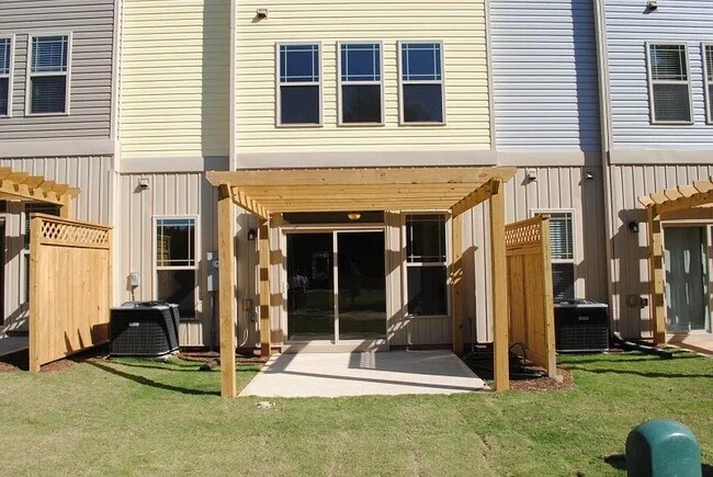 patio backing to common area with a pergola, trees, greenway trails and scenic private pond - 2908 New Hill Park Rd