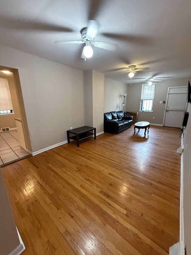 Huge Living Room With Mounted Electric Fireplace and TV - 2148 N Carlisle St Apartments