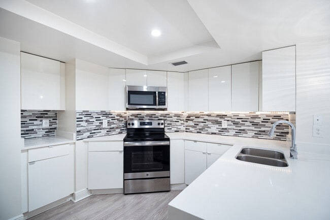 Modern kitchen with stainless steel appliances, granite countertops and designer cabinets