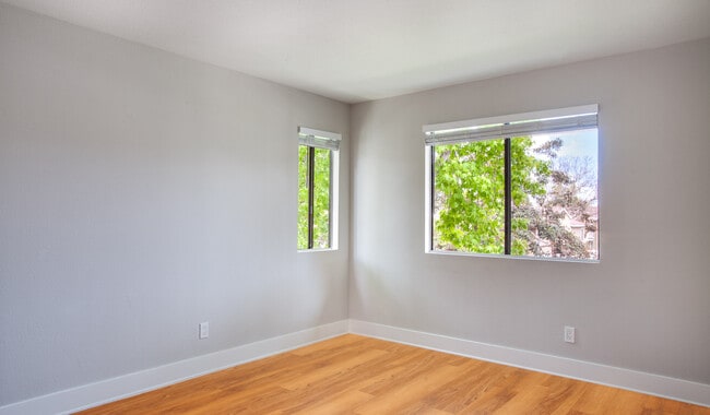 Spacious bedroom with wood flooring throughout