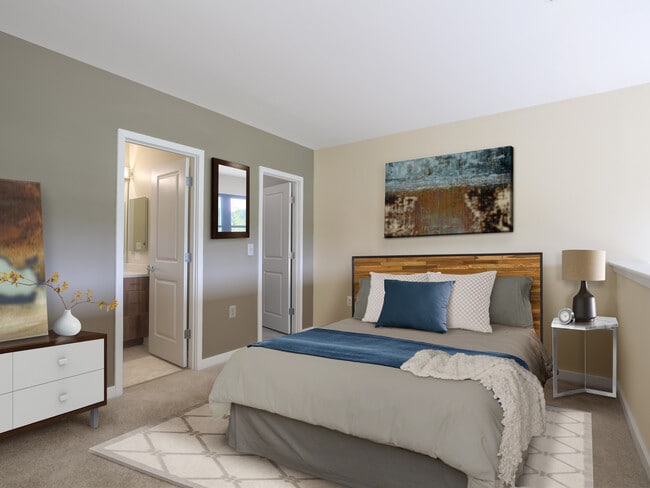 Upgraded bedroom with accent wall and carpet