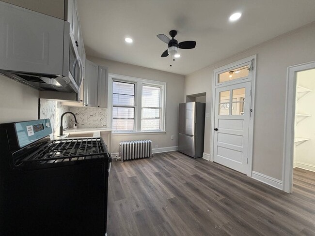 Photo - Spacious 5BR/2BA Home with Basement & Off-Street Parking