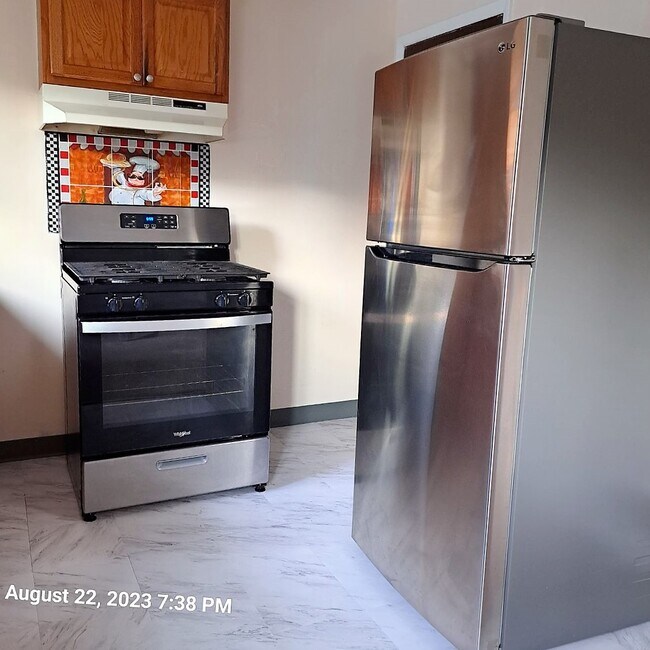 Kitchen with stainless range and refrigerator - 3309 W Run Rd