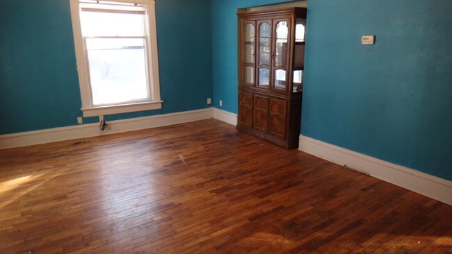 Living room has a beautiful china hutch included! - 1307 SW Mulvane St Unit A
