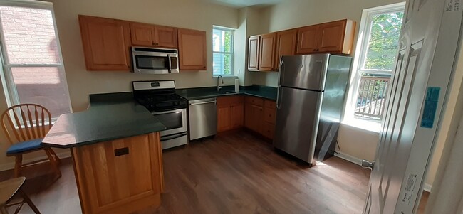 View of kitchen upon entry - 7718 Brashear St Apartments Unit 201