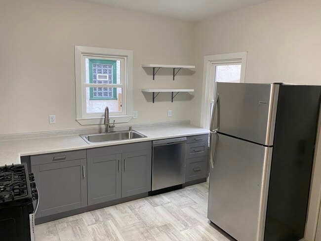 Kitchen, with Stainless Steel Fridge/Freezer and Dishwasher - 3052 California St NE Unit 1