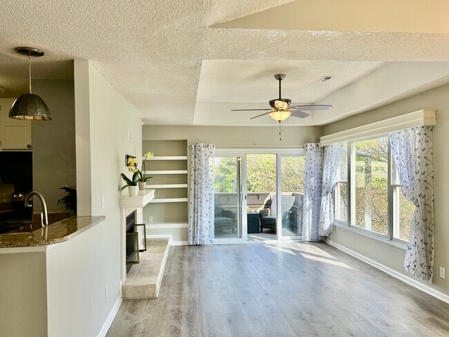 Living room with adjacent dining room and overlooking kitchen - 1101 E Morehead St Unit #48