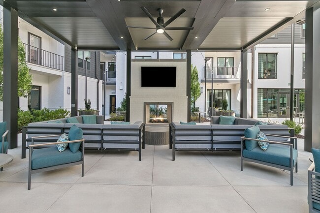 Relax in the outdoor living room with fireplace and TVs
