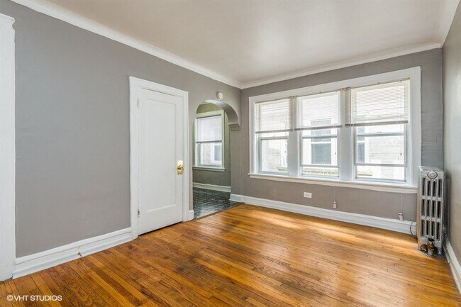 Bright living room space with natural light and hardwood floors. - 3935 W Diversey
