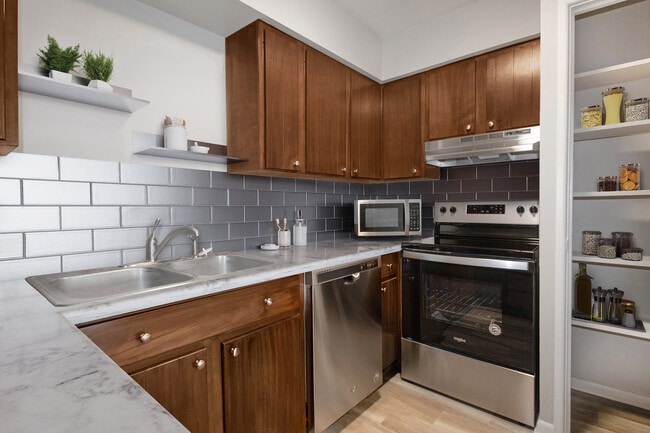 Fully Equipped Kitchen with Ample Pantry Space & Stainless Steel Appliances - Pinehill Park Apartments