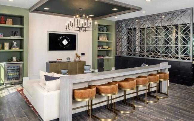 Six stools at the clubroom bar, with a sofa behind for the overflow.