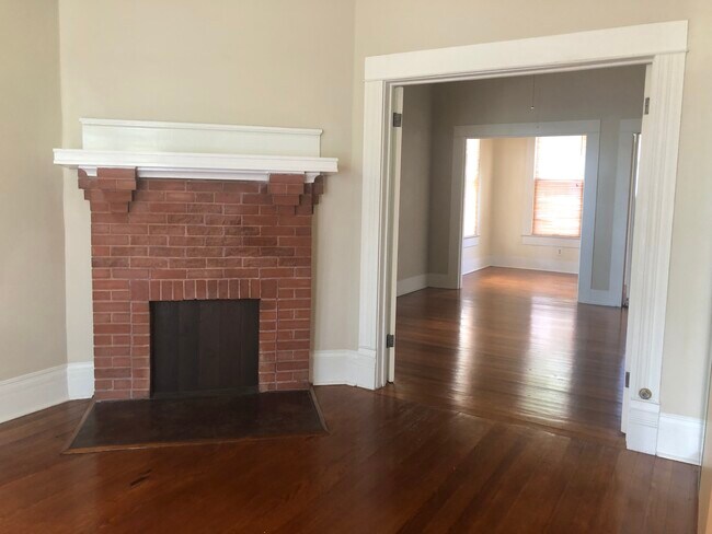 non working fireplace in the large bedroom looking thru the living area to the breakfront room - 704 E Guenther St Unit Apt 1