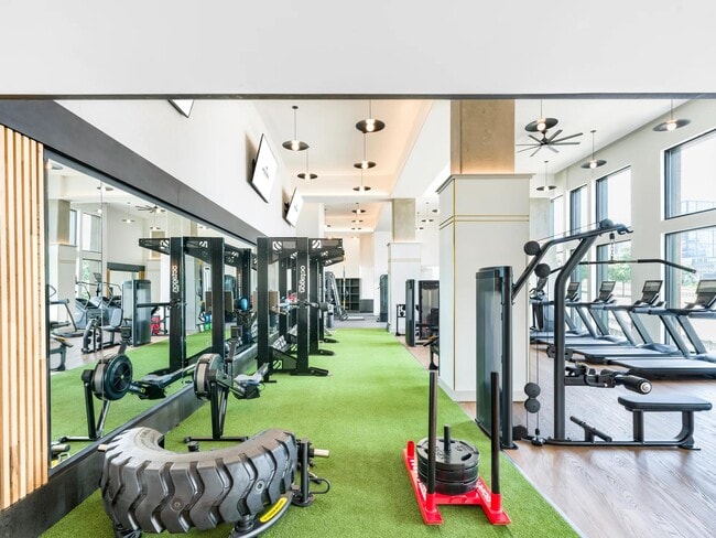 Expansive two-story fitness studio with cardio, strength, and functional training zones.