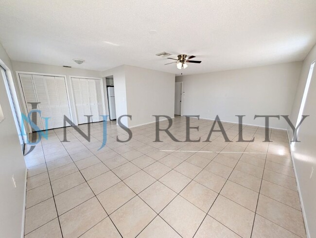 Photo - Beautifully updated 3/2/2 1500 Sq. Ft. with fenced yard, tile floors, HUGE living room and a corn...