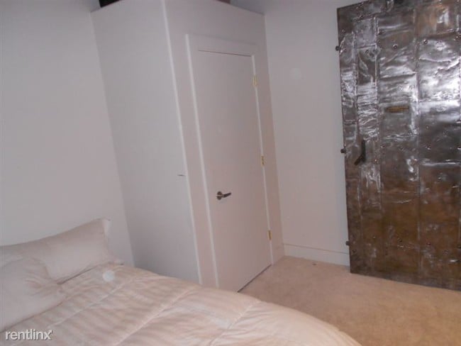 Bedroom - door is repurposed steel bank door - 600 Broadway Ave NW Unit 132