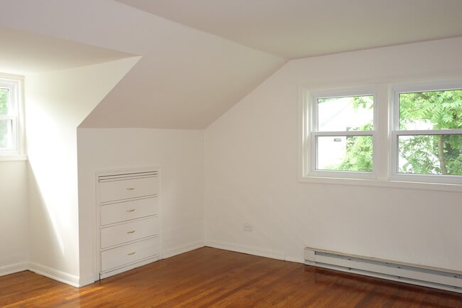 Second floor bedroom with hardwood floors and built in. - 116 Howard Dr Unit Apt #1