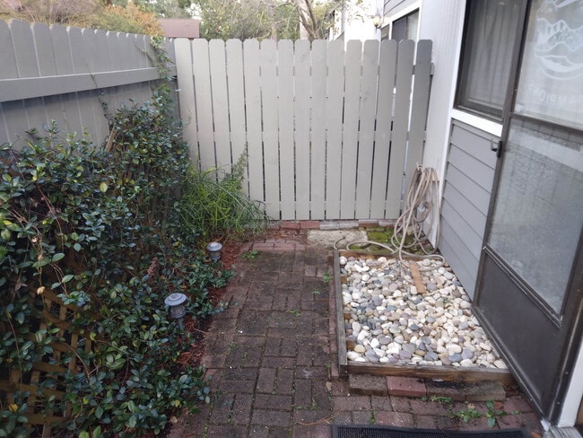 foot bath and small garden on either side of fence
