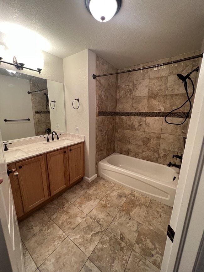 Double sink and tub shower - 15234 W 63rd Ave Unit 203