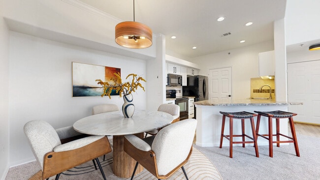 Dining Area overlooking kitchen and bar area - 6021 Castlegate Dr W Unit E25