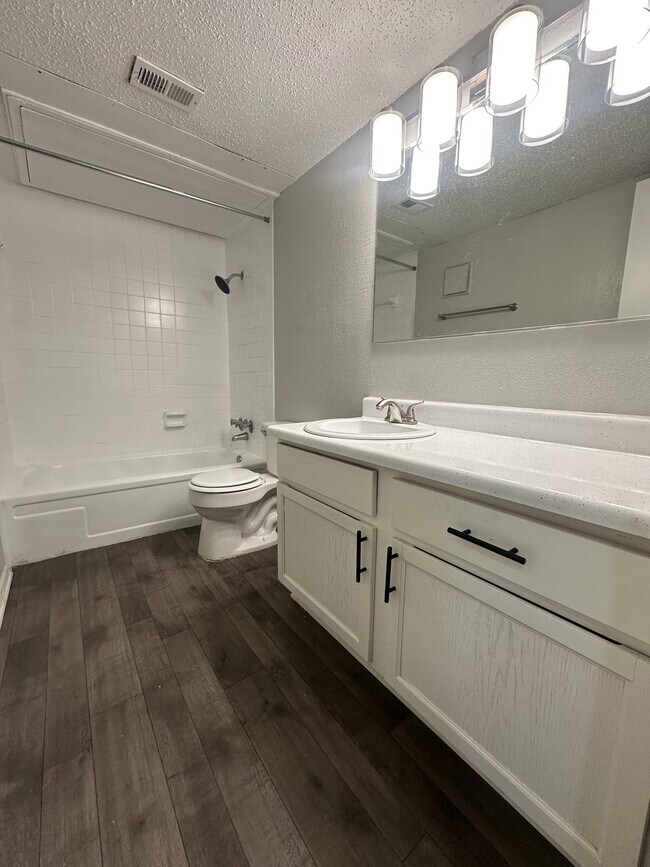 Spacious Bathroom with White Cabinetry and Large Mirror