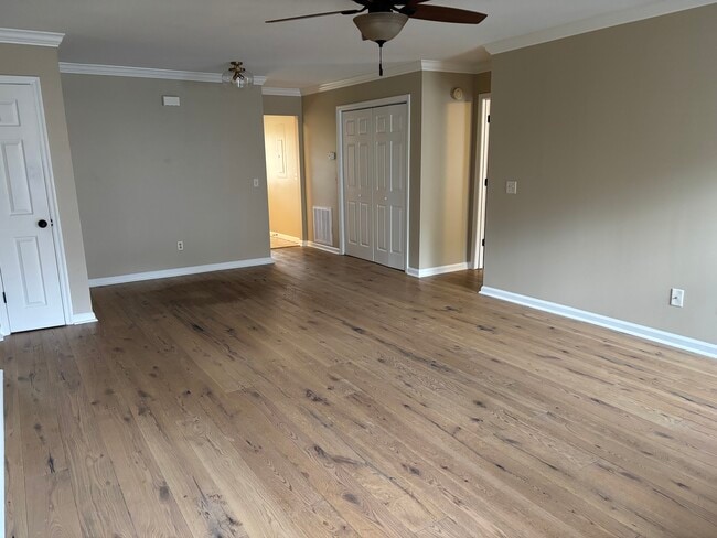 Living room / washer and dryer hookups behind bifold doors - 1315 Moice Dr Unit #2