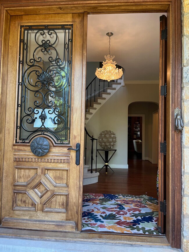 Double doors leads into formal foyer with wrought iron spiral staircase - 5553 Little Falls Rd