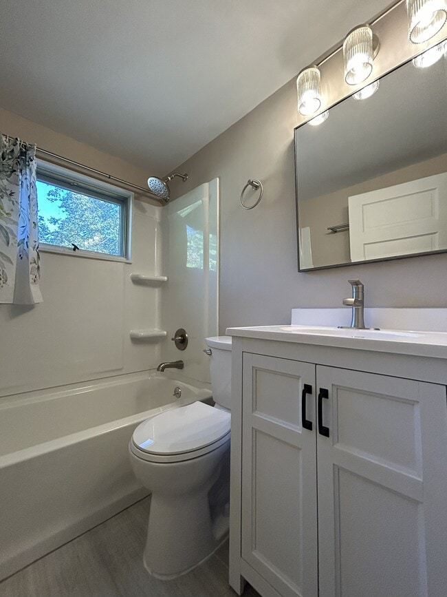 Brand new tile flooring, bath tub, vanity, mirror, light fixture and toilet. - 1231 Raymond Ave