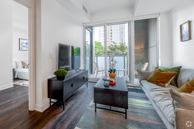 1BR + Den, 2BA - 734SF - Living Room - 3030 Pharmacy Avenue