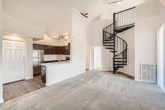 A Kitchen with a Spiral Staircase at Fox Run Lofts - Fox Run Lofts