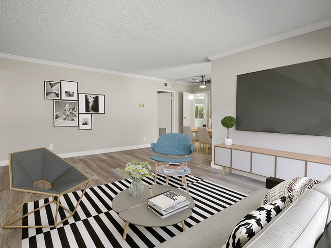Hardwood floored living room with view of dining room. - Tilden II Apartments