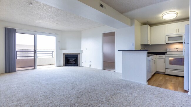 Carpeted Living Room with Fireplace and Balcony