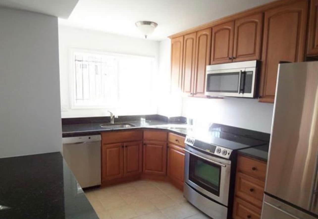 Kitchen with peninsula and stainless steel appliances - 1386 Bryant St NE Condo Unit 101