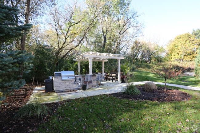 Outdoor kitchen with gas and charcoal grilling areas