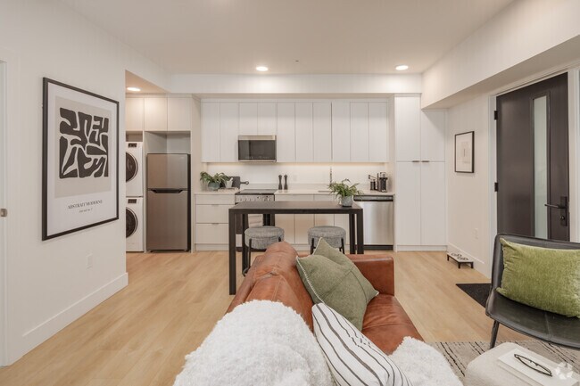 2BR, 2BA - 696SF - Living Room and Kitchen - Raven Apartments