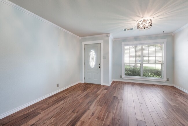 Photo - Modern Elegance: 3-Bedroom Townhome with Wood Flooring, Shaded Deck, and Inclusive Amenities