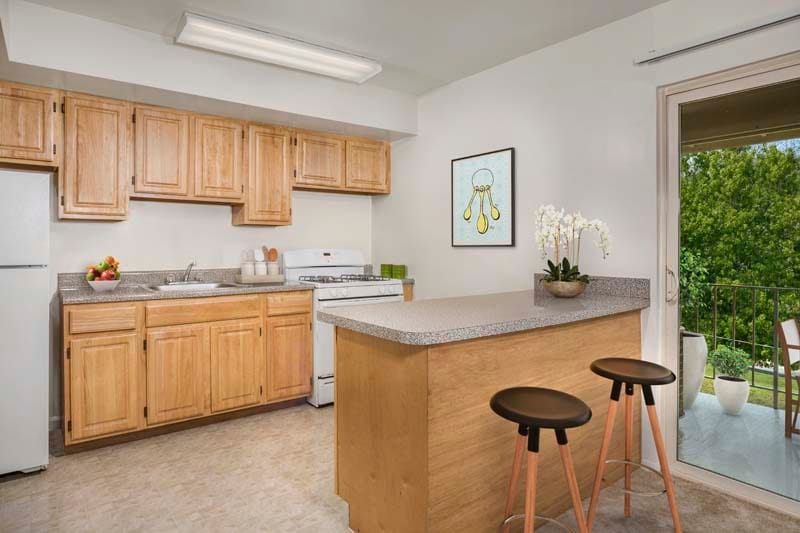 Well equipped kitchen with a breakfast bar at Chestnut Hill Apartments