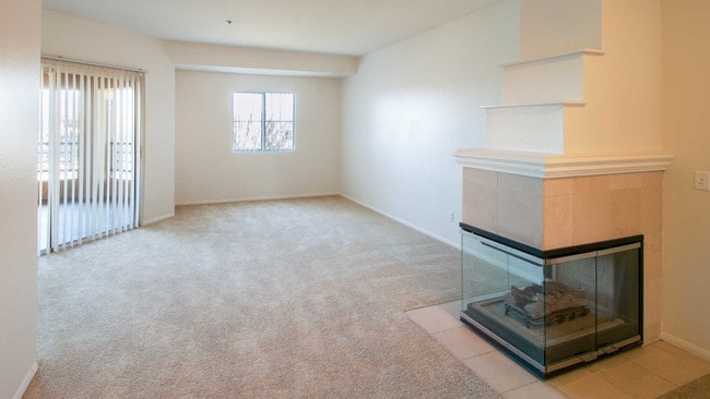 Carpeted Living Room with Gas Fireplace and Balcony