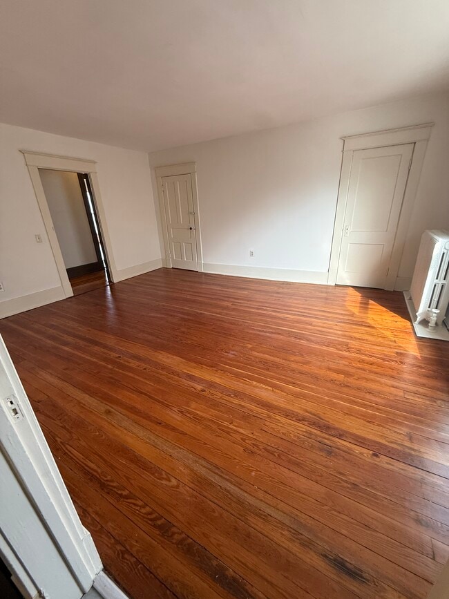 Large living room with closet space and newly refinished hardwood floors - 428 S Main St Unit 2