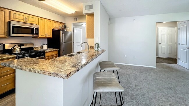 Enjoy the open layout of our spacious kitchen and breakfast bar, perfect for casual dining and entertaining guests.
