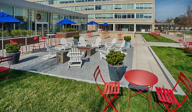 Spacious outdoor courtyard with patio furniture and and charcoal fire pit