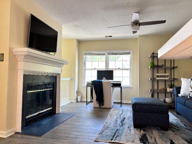 Living room view: alternate view from dining area. - 704 Rapidan River Ct Unit E