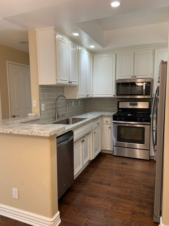 New kitchen - granite and backsplash - 14415 Benefit St Unit 102