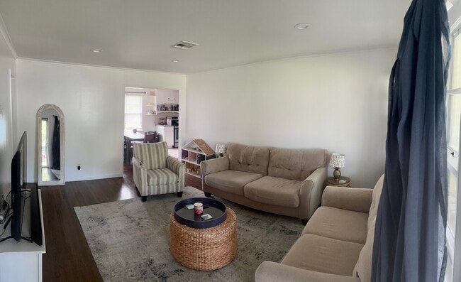 living room. standing at front door. - 3516 E 30th St