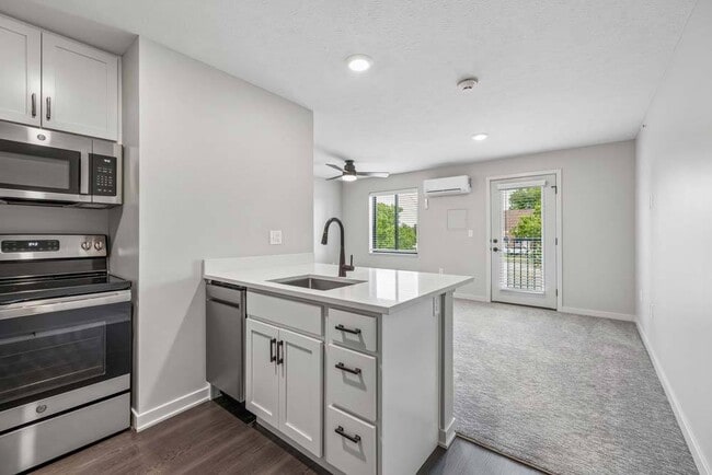 A spacious kitchen island anchors the home’s open-concept design, creating a natural gathering place that flows seamlessly into the bright living area.