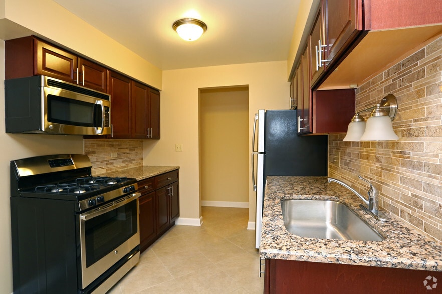 Kitchen with granite tops and stone backsplash