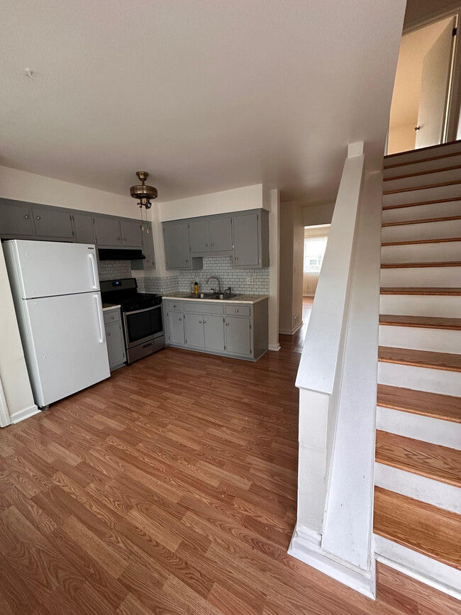 View of kitchen and stairs to second floor bedrooms from backdoor (parking lot) - 163 S 4th Ave Casa Adosada